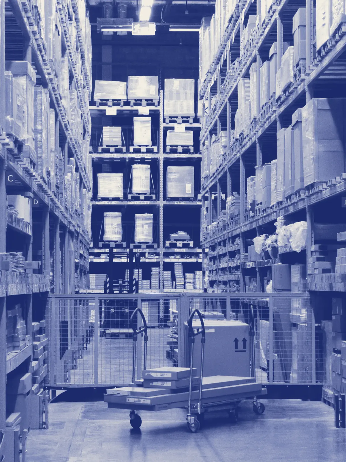 Warehouse aisle with tall shelves of boxed stock